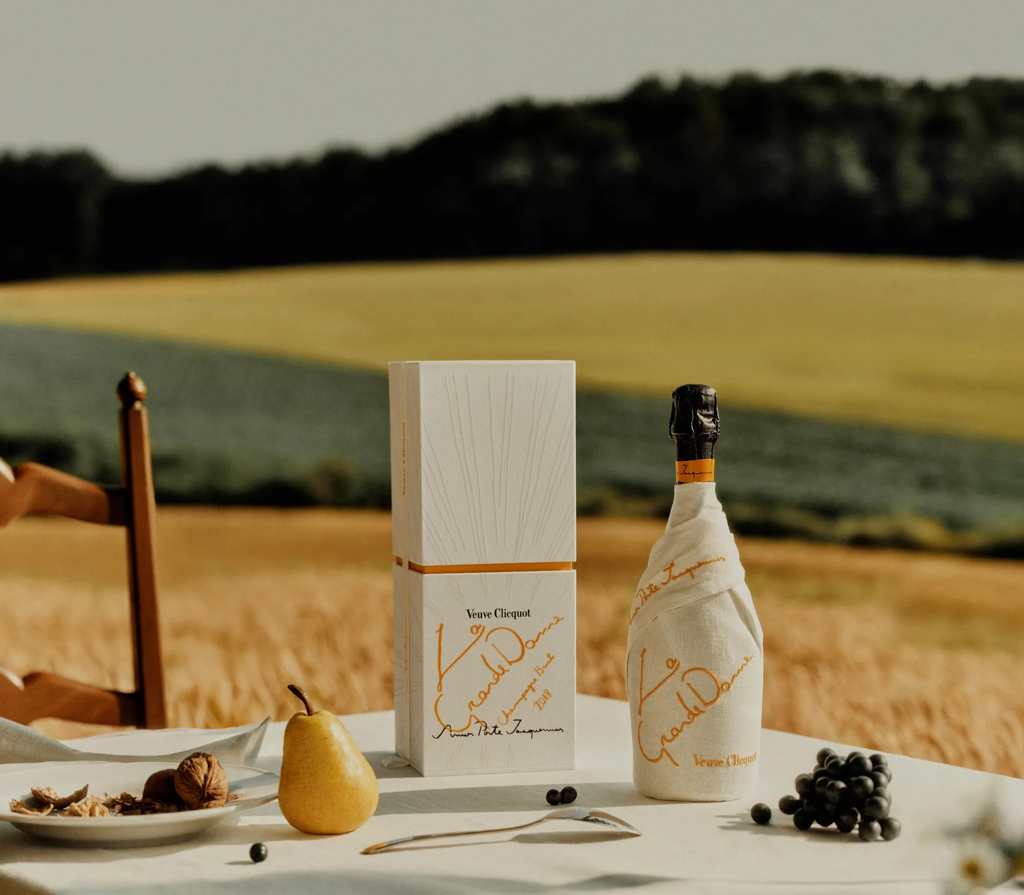 Bouteille de champagne La Grande Dame 2018 habillée d’un drapé en lin blanc, édition limitée conçue par Jacquemus pour Veuve Clicquot.